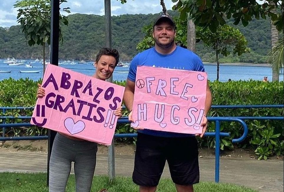 Couple offering free hugs to spread love, connection post image