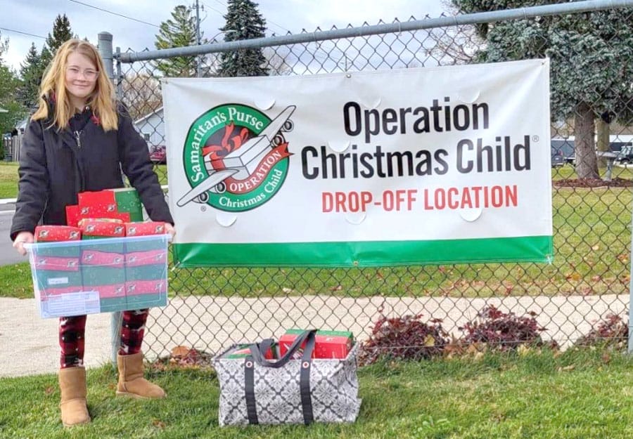 Youth pack shoeboxes to help kids through Operation Christmas Child post image