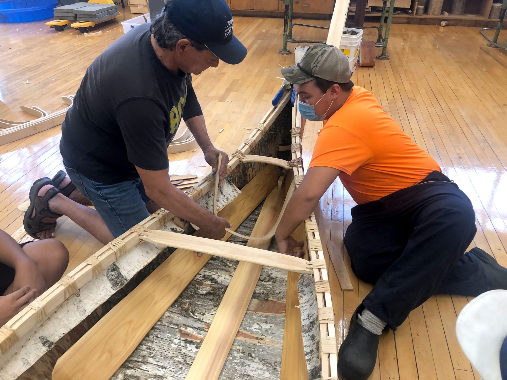 Local Indigenous students participate in traditional birch bark canoe build