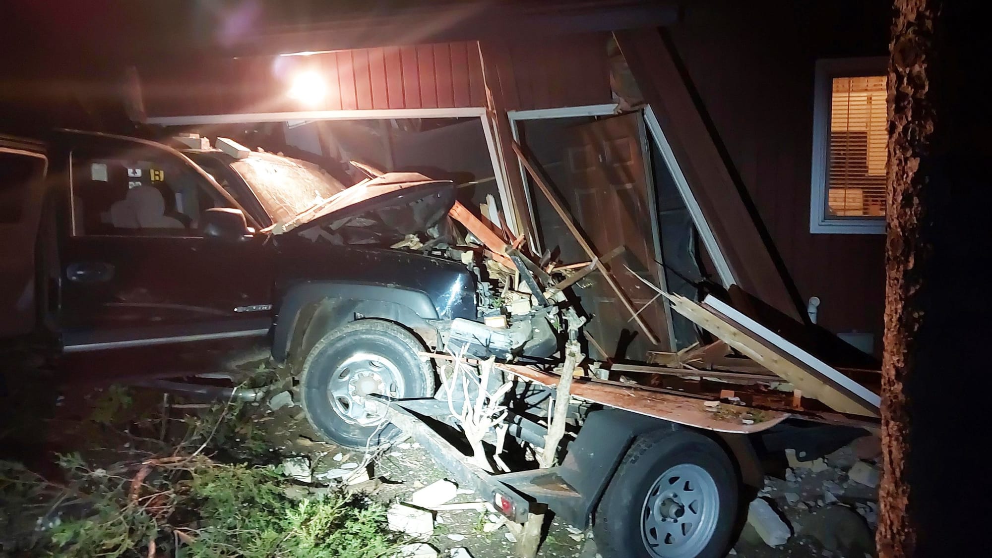Police seek suspect after stolen truck crashes into home
